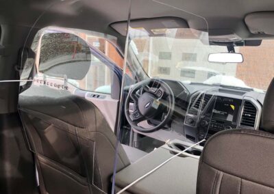 Sneeze guard barrier for vehicle between driver and passenger